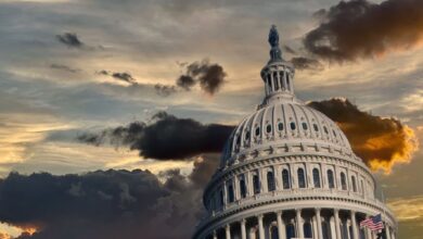 Capitol dome under dark dramatic storm clouds