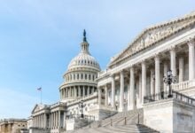 United States Capitol east front with wide steps and columns on clear day